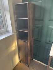 5-tier tall storage cabinet with a single door in walnut brown.