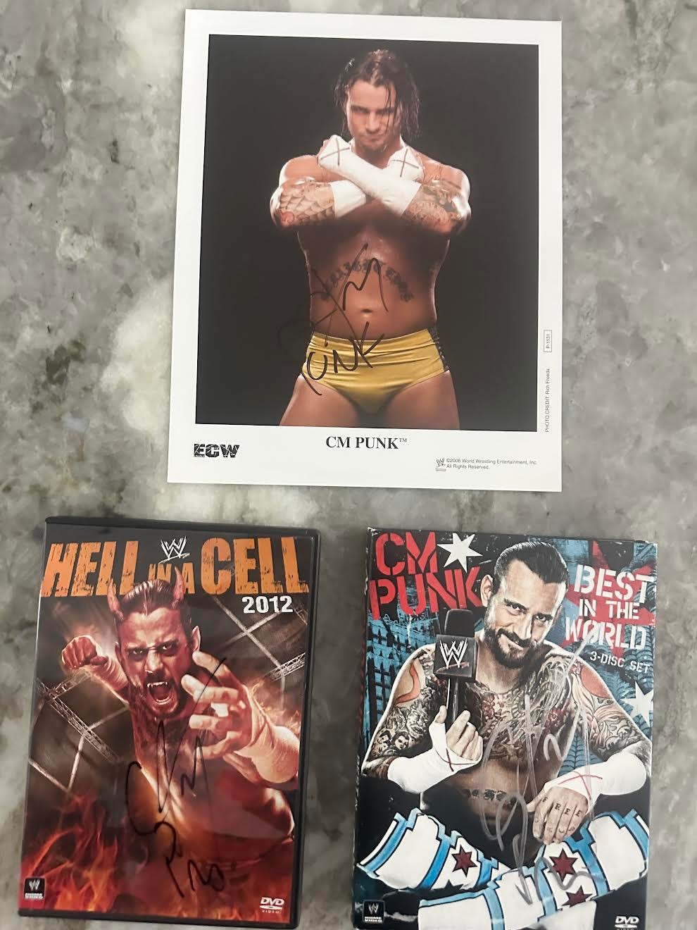 3 Pack of WWE Autographs of CM Punk! 2 DVDs and a CM Punk 8x10!