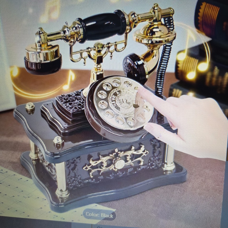 A fully functional rotary phone that plays music when you pick up the handset — pure mid-century desk theater.