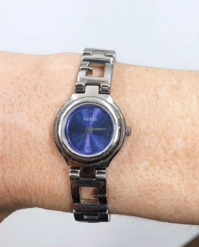 silver guess watch with blue face