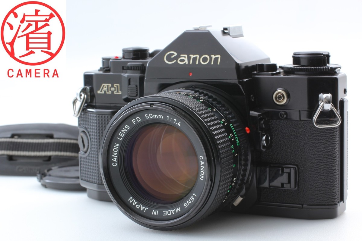 Near MINT] Canon A-1 black body 35mm SLR + NFD New FD Lens