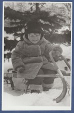 Beautiful Child in a fur coat sledding in the snow. Soviet Vintage Photo USSR