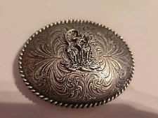 Belt buckle with a cowboy roping a cow B120