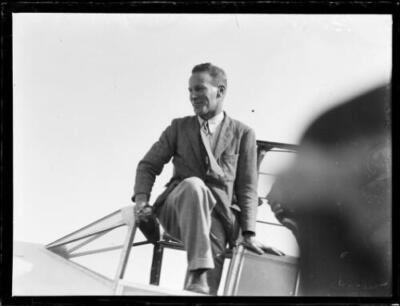 Aviator Charles Kingsford Smith climbing out of a cockpit at Masco- Old Photo