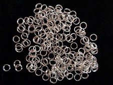 Split ring, imitation silver steel, 8mm round, 6.6mm inside diameter.