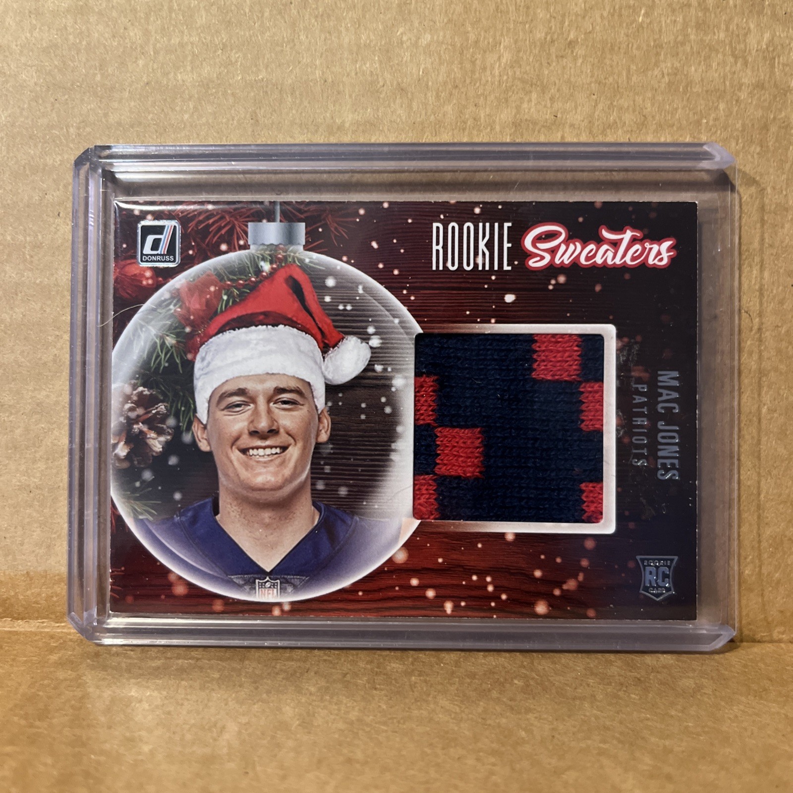 Mac Jones Panini Donruss Rookie Holiday Sweater Memorabilia #RSMJO Base