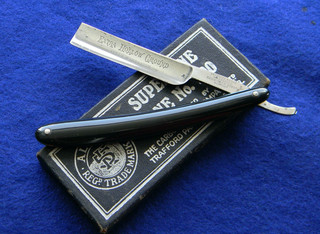 Excellent "slick black" bakelite handled straight razor extra hollow ground.