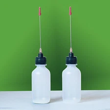 Two 2 OZ bottles with needle tip dispenser