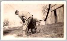 Vtg B&W Snapshot Man In Cap Working With Calf By Barn Rural Farm Life 1940s