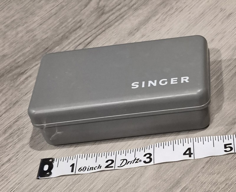 Singer Sewing Macine Accessories In A Gray Plastic Case