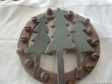 Primitive wood round circle with bells and wood trees. Painted green. Wire 