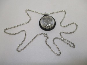 John Fitzgerald Kennedy 1917 - 1963 Pendent with Chain and 1988 Half Dollar