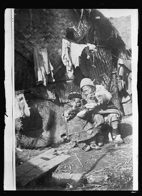 Photo:China 1920s Mother Child Eating Outside Hut Asian Village