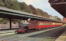 Coloured postcard IOM steam loco with cariages in station 0141
