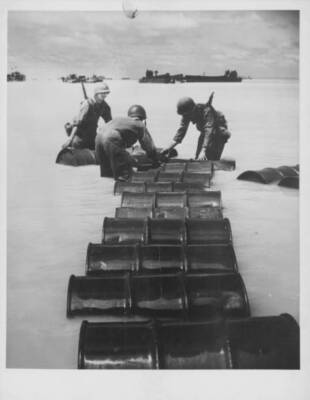 Soldiers rolling out supplies during allied invasion Iwo Jima duri Old Photo