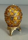 gold & rhinestone hinged collectible (Easter) egg with gold feet, yellow interi