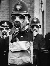 Parade police officers wearing gas masks at East Ham Police stati- 1937 Photo