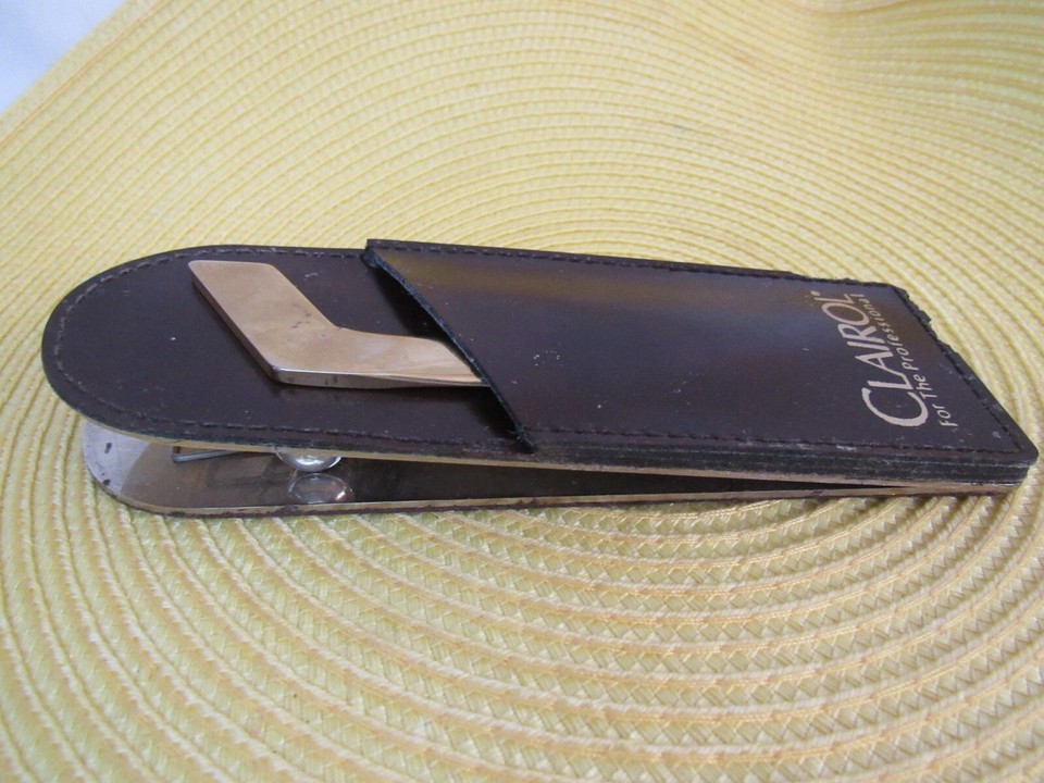 A Clairol-branded MCM letter opener with leather sheath made in Italy — a bizarre and delightful corporate promo relic from the beauty industry.