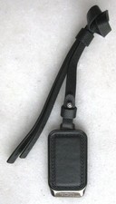 TUMI TAG, NEW, Black Leather, Silver-color metal plate, Model: Purse Voyage