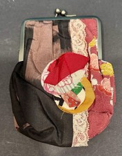 Decorative handmade coin purse with a clasp featuring patchwork fabric and lace