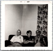 Vtg Snapshot Three People Sitting On Couch Glasses Patterned Curtain 1958