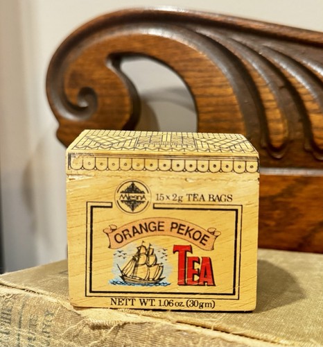 Vintage Mlesna Orange Pekoe tea wooden box with tea bags.