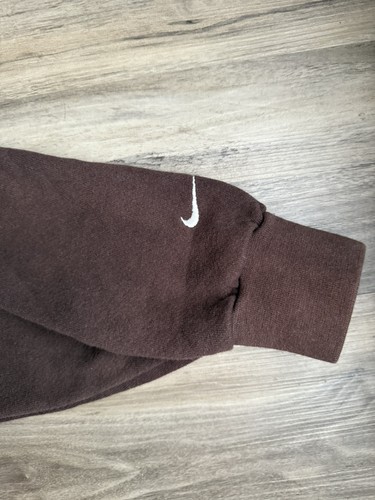Brown vintage Nike sweatshirt with white swoosh logo on left sleeve, made in USA.