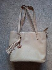 Beige leather Radley tote bag with a tassel charm.