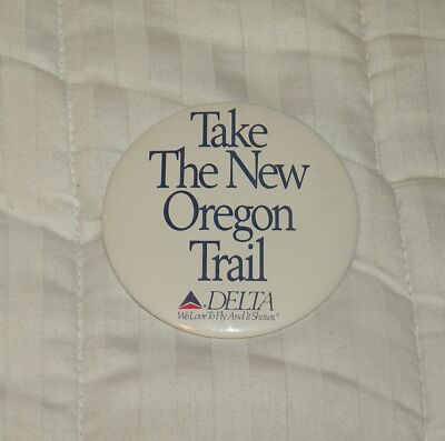 DELTA AIRLINES PINBACK BUTTON TAKE THE NEW OREGON TRAIL