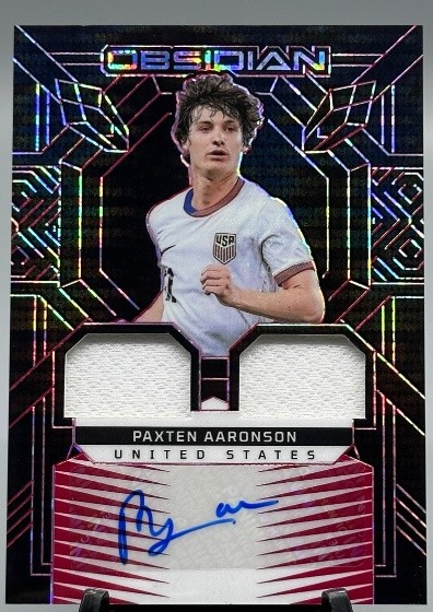 Paxten Aaronson 2024-25 Panini Obsidian Dual Patch Auto Red Pulsar 50/99 #DJ-PAA