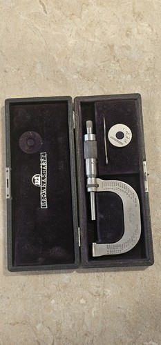 Brown & Sharpe micrometer No. 48 with silver metal shaft, black hard case, and printed brand label on lid.
