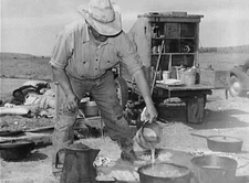 8" x 10" Camp cook at work with chuckwagon in background