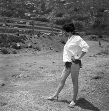 1950s Negative-sexy brunette pinup girl by dirt road-cheesecake t920842