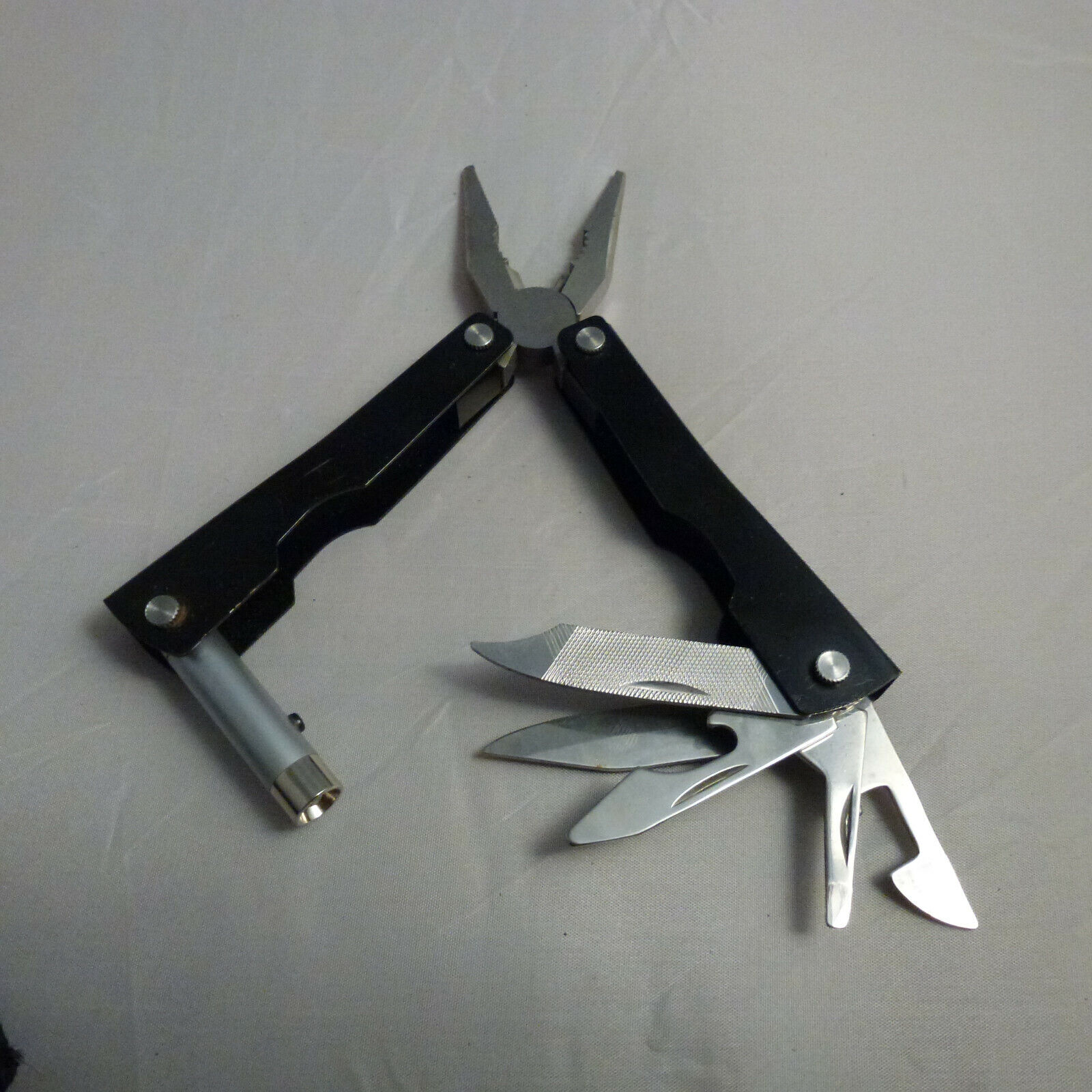 Combination ( leatherman style ) Tool with flash light for Travel or Camping 