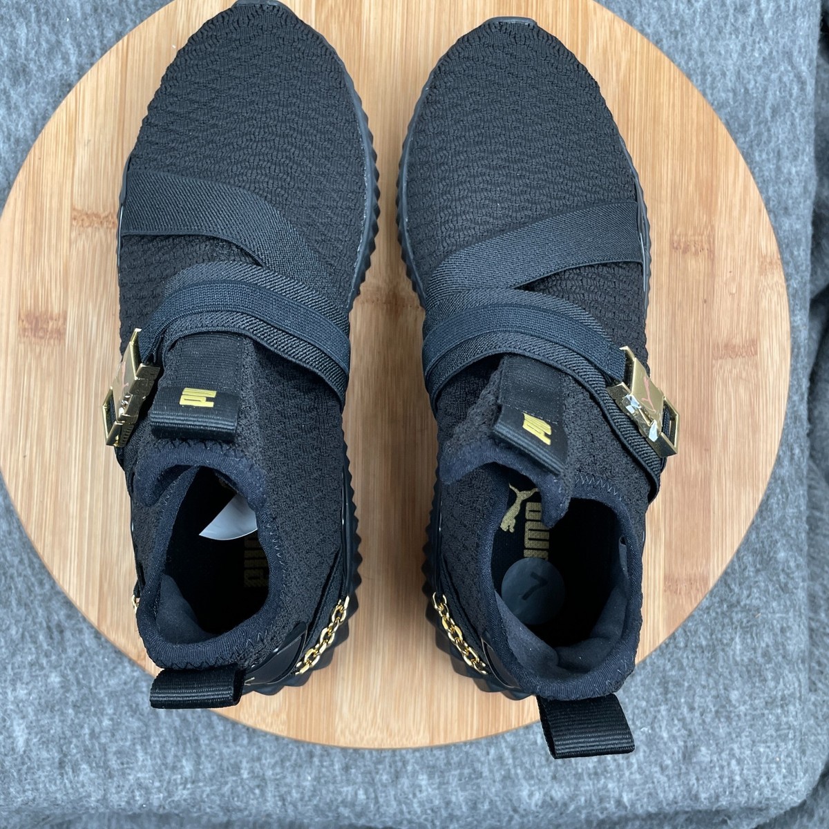 puma defy varsity black and gold