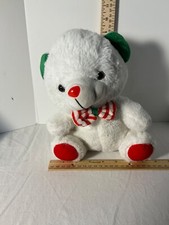 White plush bear with green and red accents and bow tie