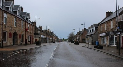Photo 12x8 Allness on a Wet Morning Alness Looking down High Street c2018