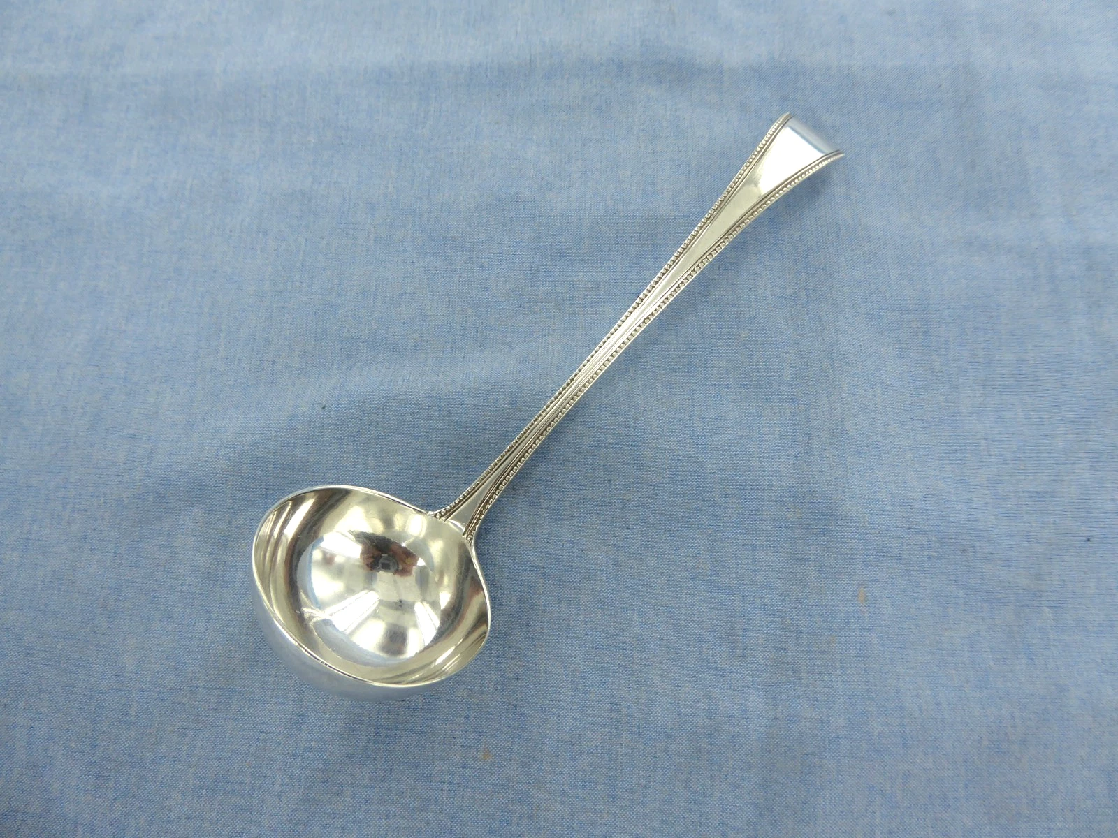 AN ANTIQUE STERLING SILVER OLD ENGLISH BEAD SAUCE LADLE. LONDON 1864.