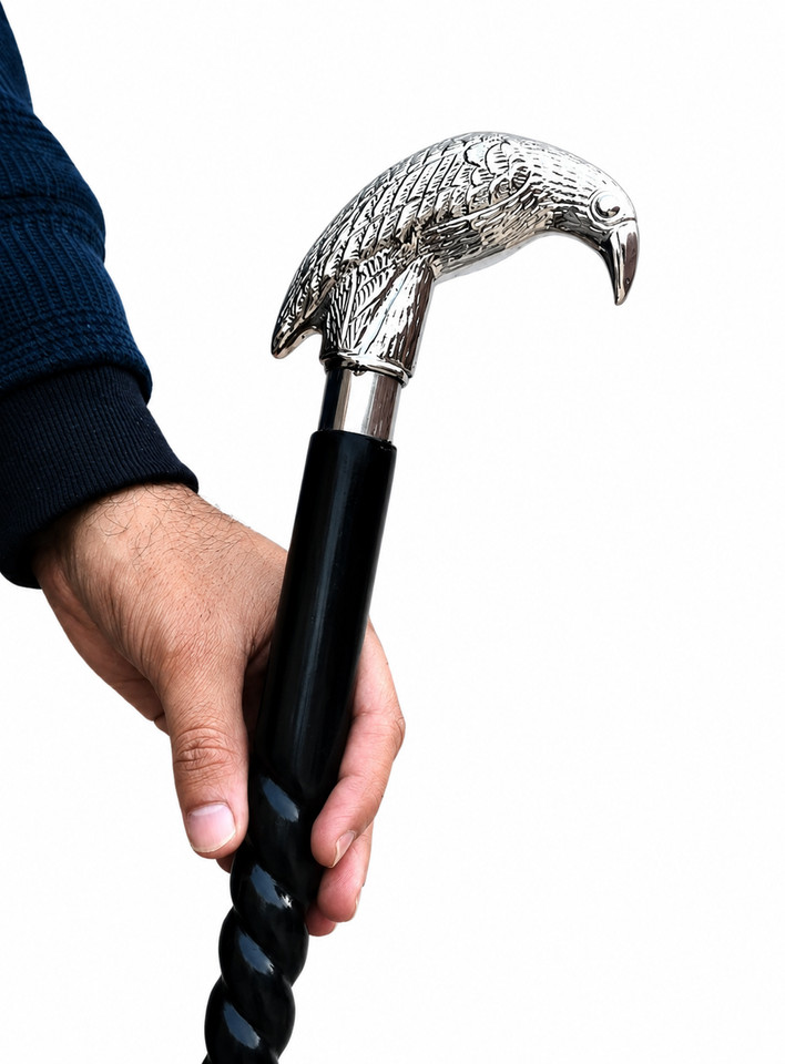 A silver bird-head handle walking cane with a twisted black shaft — the kind of dapper prop that makes every entrance unforgettable.