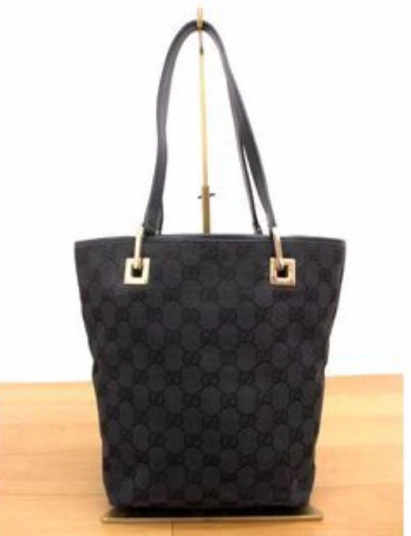 Sac fourre tout noir GUCCI GG line très bon état avec sac de rangement Gucci