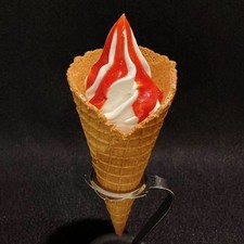 Food replica: Waffle cone vanilla soft serve ice cream with strawberry sauce
