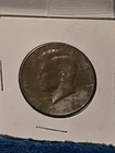 1991-D Kennedy Half Dollar with Nickel plate off of front - copper showing