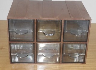 Bank of six small pull out drawer units.