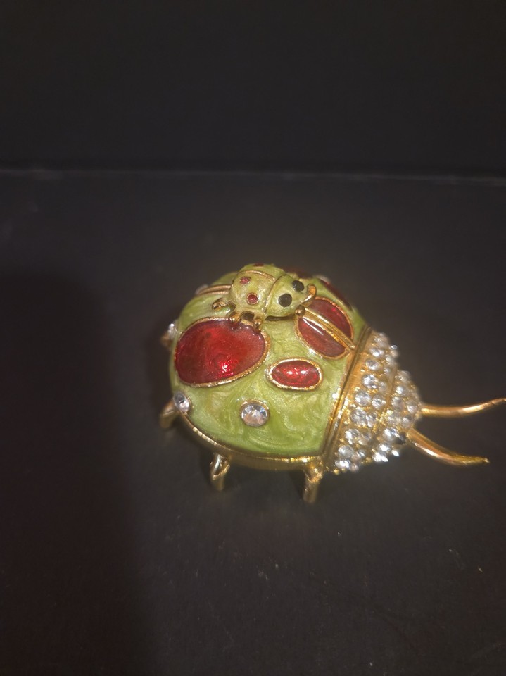 Jeweled enamel ladybug trinket box with a magnetic closure — miniature, visually striking, and genuinely collectible vintage charm.