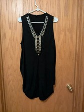 A sleeveless black shift mini dress