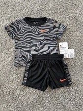NWT. NIKE 2-PIECE GRAY/BLACK/ORANGE SHORTS AND T-SHIRT SET. SIZE 12 MONTHS. BOYS