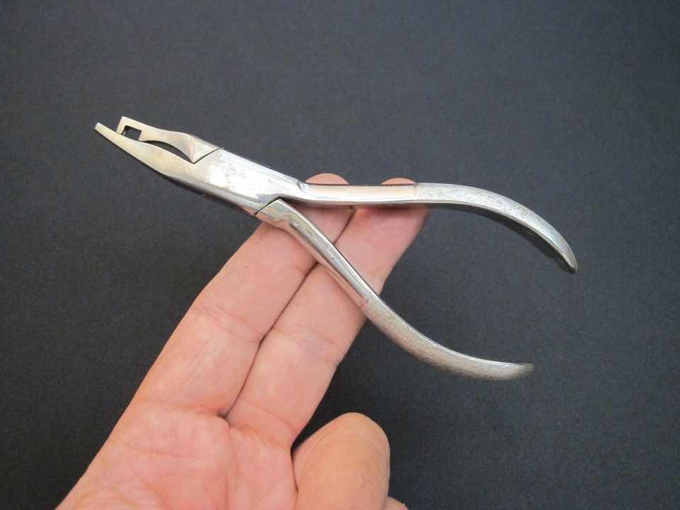 Miniature antique jeweler's pliers with the satisfying heft and patina of a real working tool from another era.
