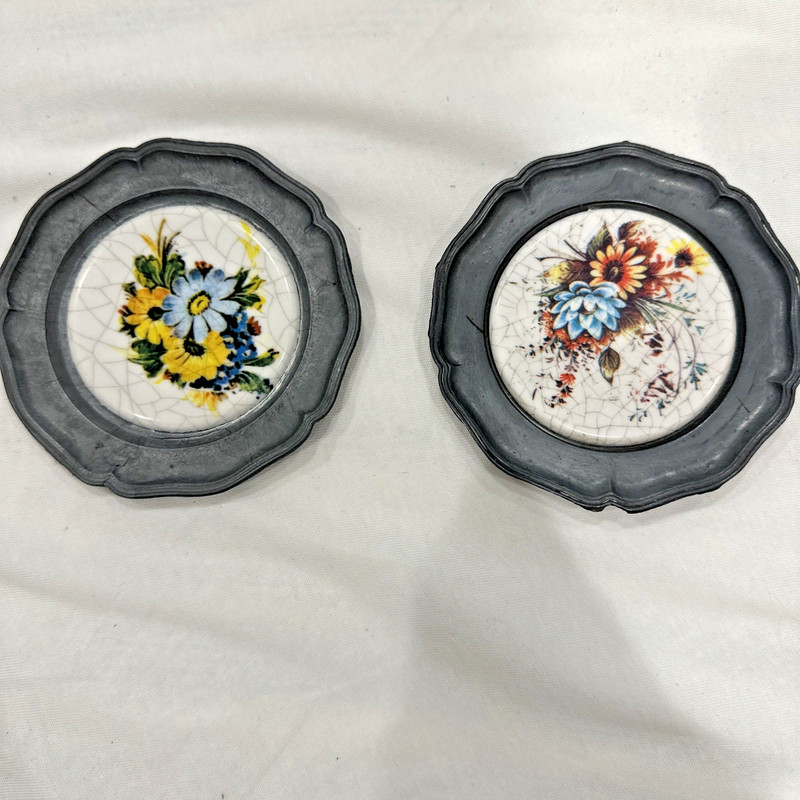 vintage German pewter plates featuring ceramic floral inlays