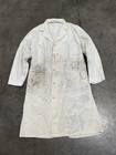 White vintage painters smock work wear with stained chest and shoulders, button front, and two large front pockets.