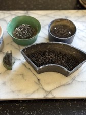 Mixed Lot of 4 Vintage Metal encased Base Pin Flower frogs   .